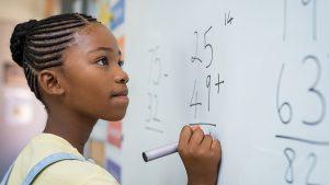 Girl solving mathematical addition