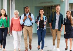 A group of happy teachers walking in a school corridor